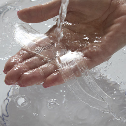 Close-up of hand in water, washing the Innovative Brow Stencil
