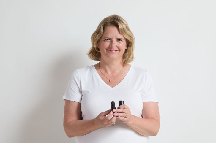 Woman using the Jenn of Arch Bold Brow Duo Stencil Kit to shape and define her eyebrows.