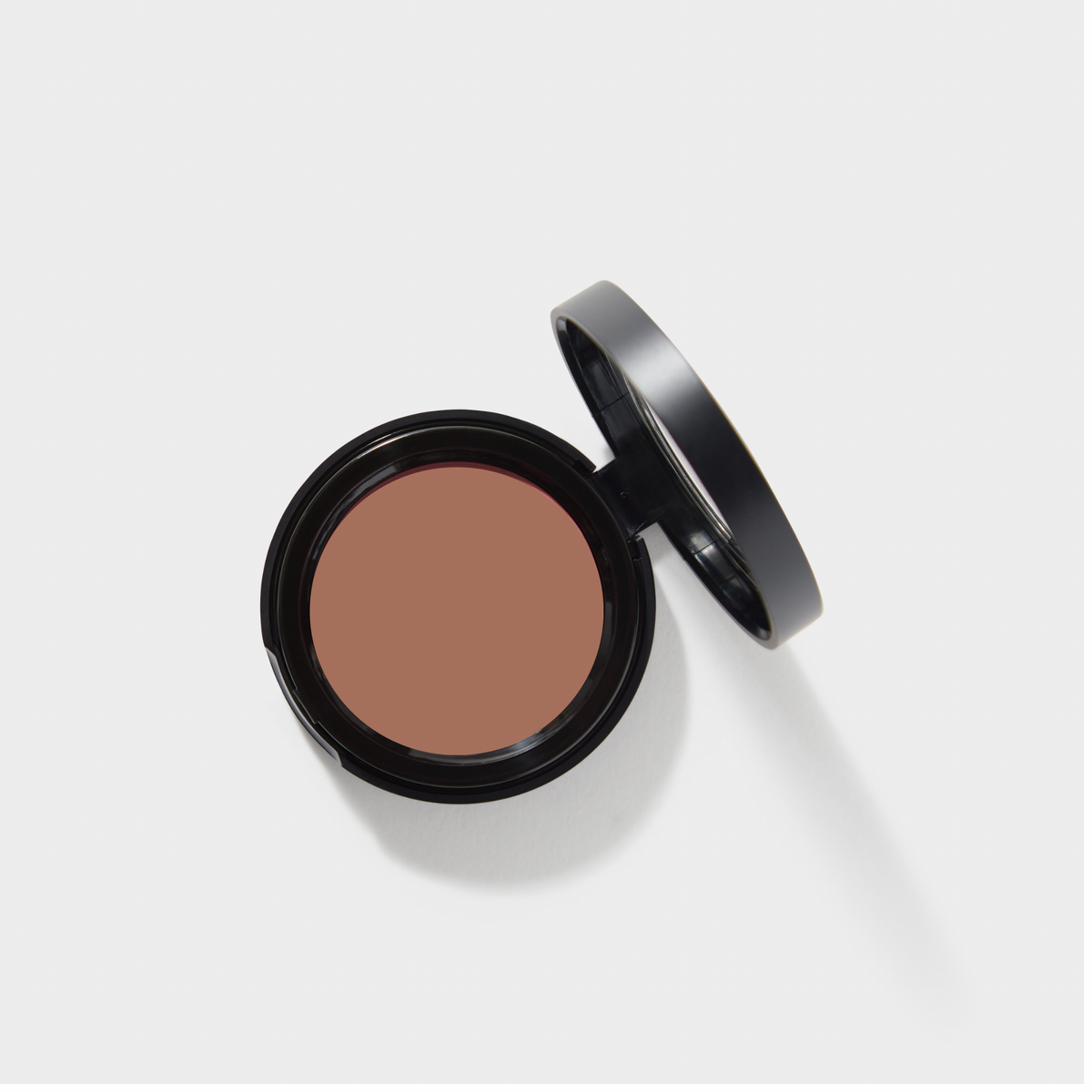 Jenn of Arch Cream Cheek and Lip Tint blush, showcasing a compact container with the tinted cream inside and a soft application brush
