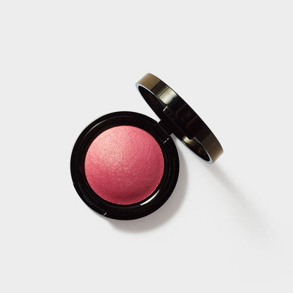 Jenn of Arch Sweet Cheeks Baked Blush in soft pink, showcasing smooth, blended application on a makeup brush.