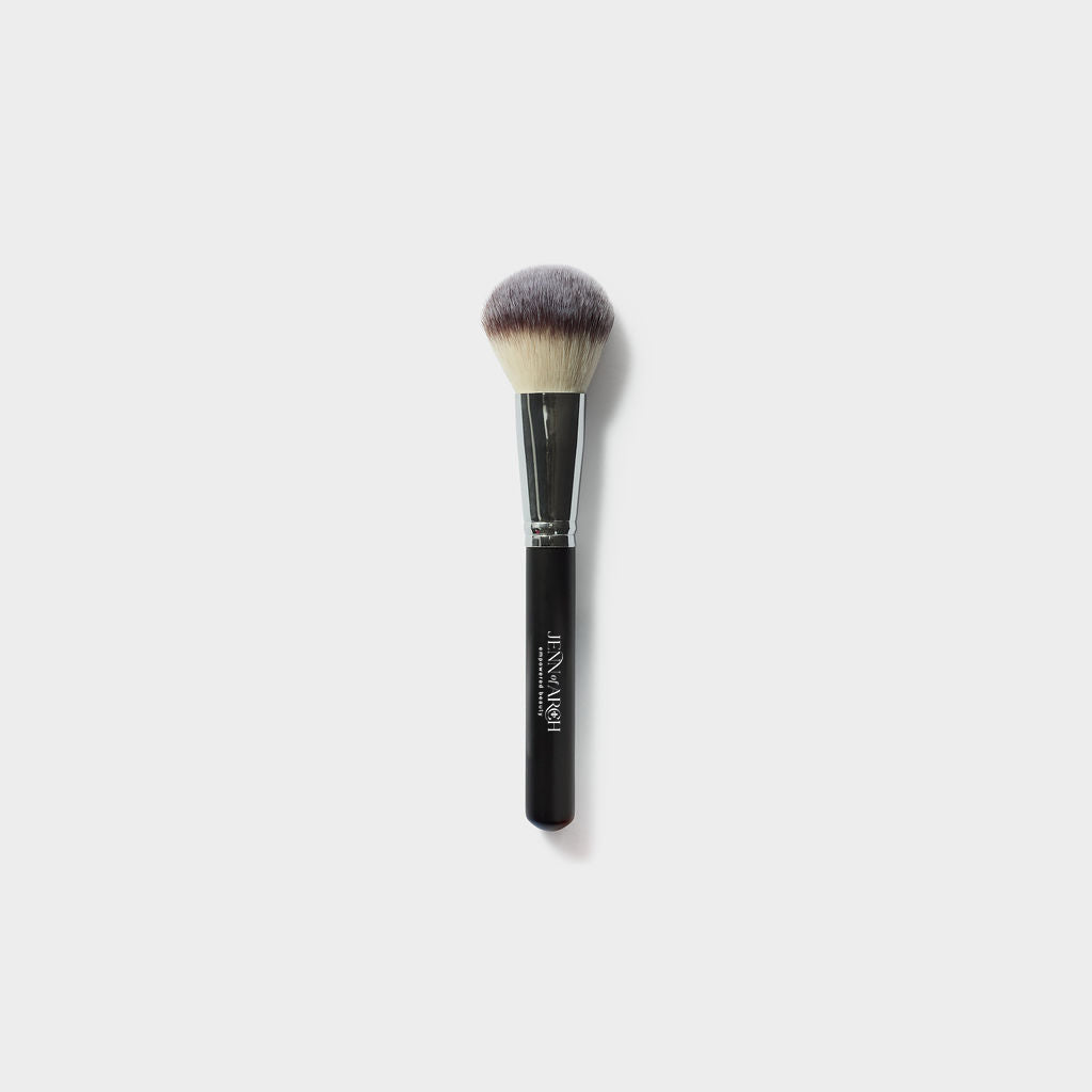 Jenn of Arch Deluxe Chisel Powder Brush with dense bristles for precise powder application and sculpting.