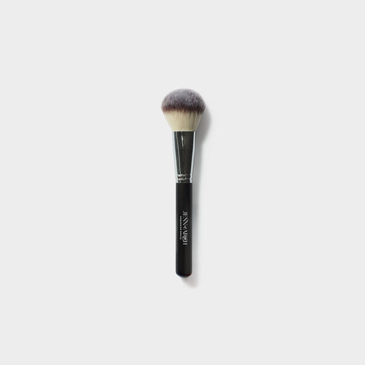 Jenn of Arch Deluxe Chisel Powder Brush with dense bristles for precise powder application and sculpting.