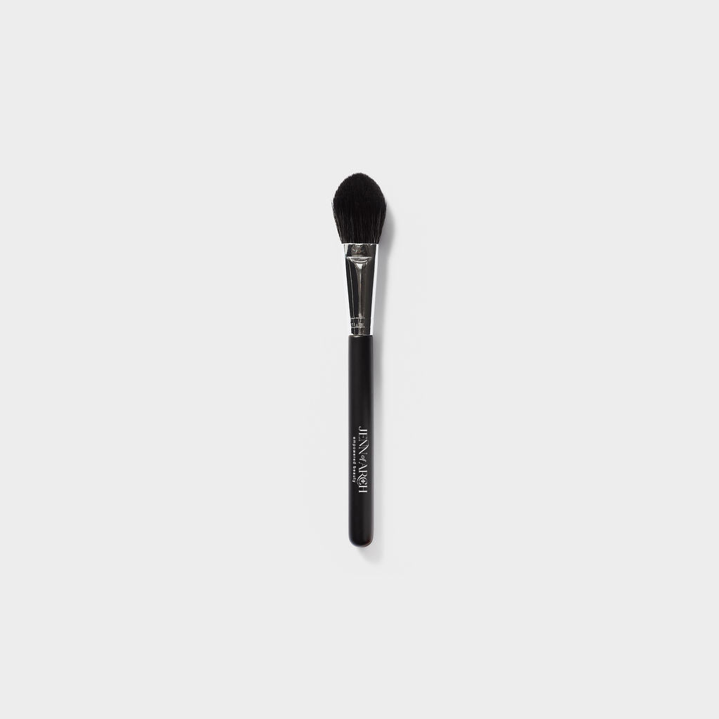 Jenn of Arch Pro Chisel Blush Brush with tapered bristles for precise application of blush and contour makeup.