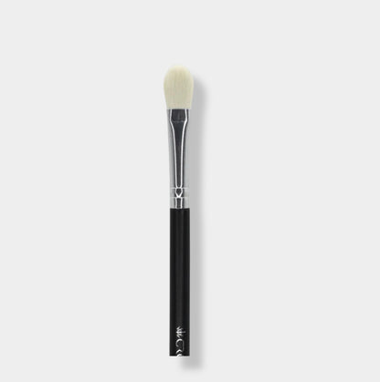Jenn of Arch tapered base eyeshadow brush with soft bristles for precise application, shown with the brush and eyeshadow on a clean surface.